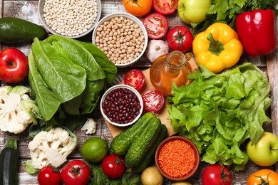 Different vegetarian products on wooden table, top view