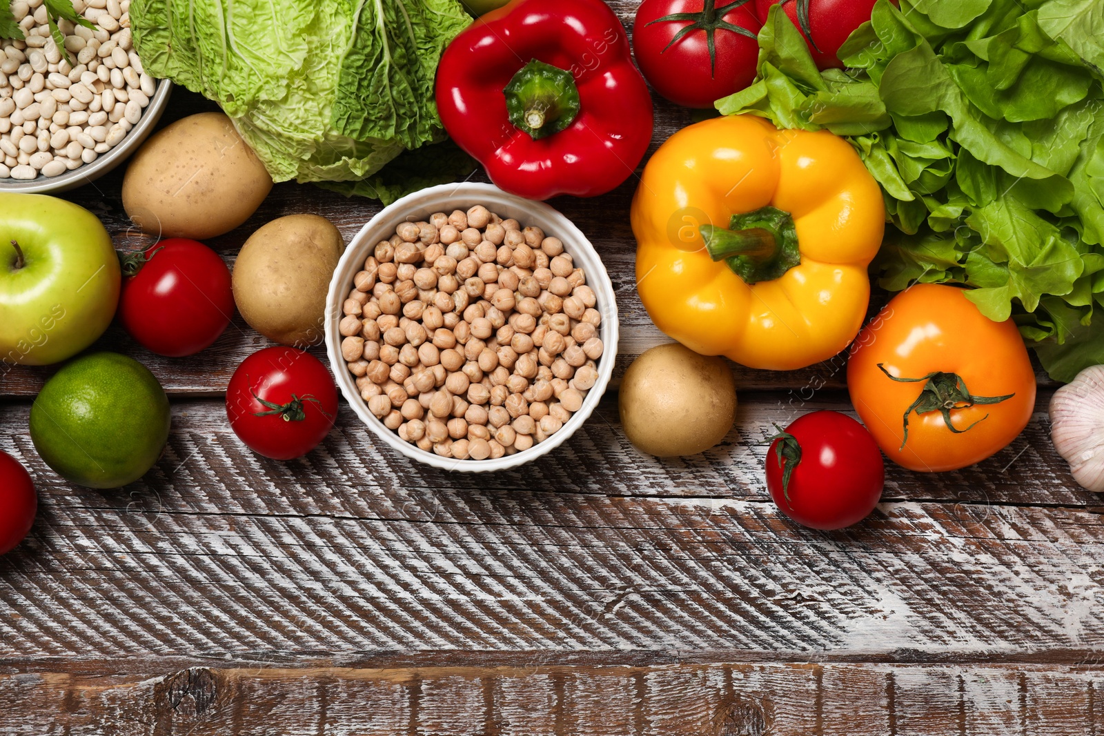 Photo of Different vegetarian products on wooden table, top view