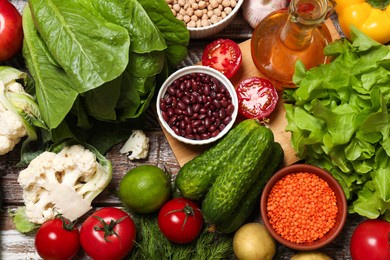 Photo of Different vegetarian products on wooden table, top view