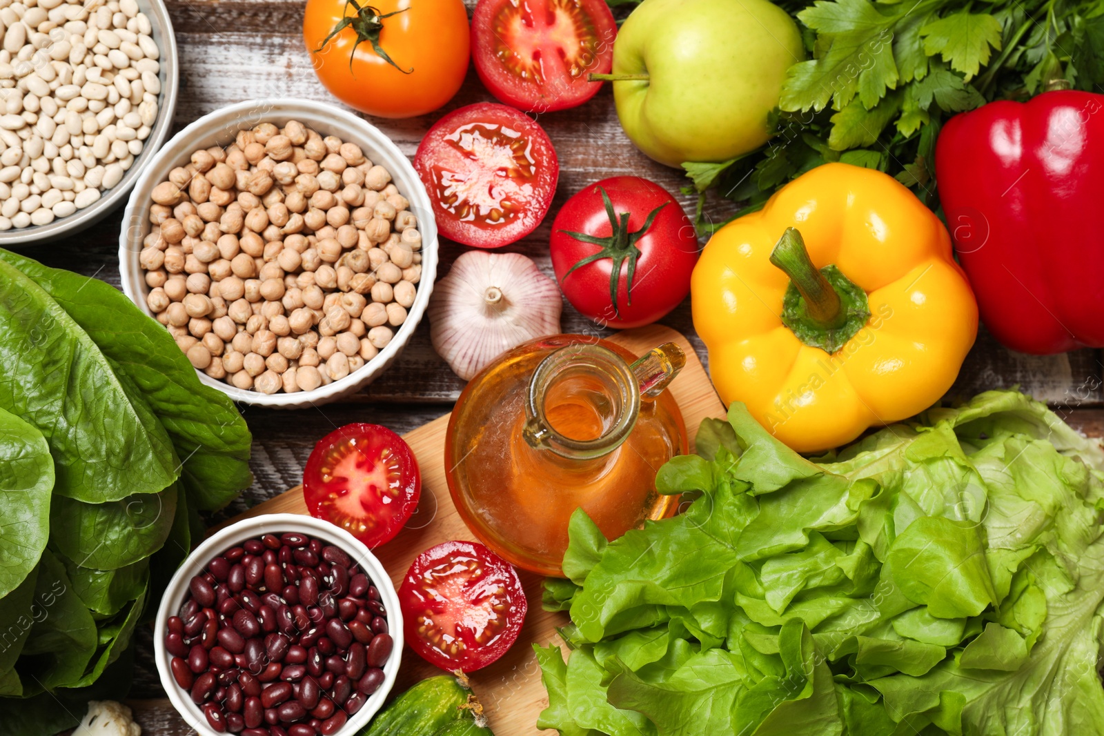 Photo of Different vegetarian products on wooden table, top view