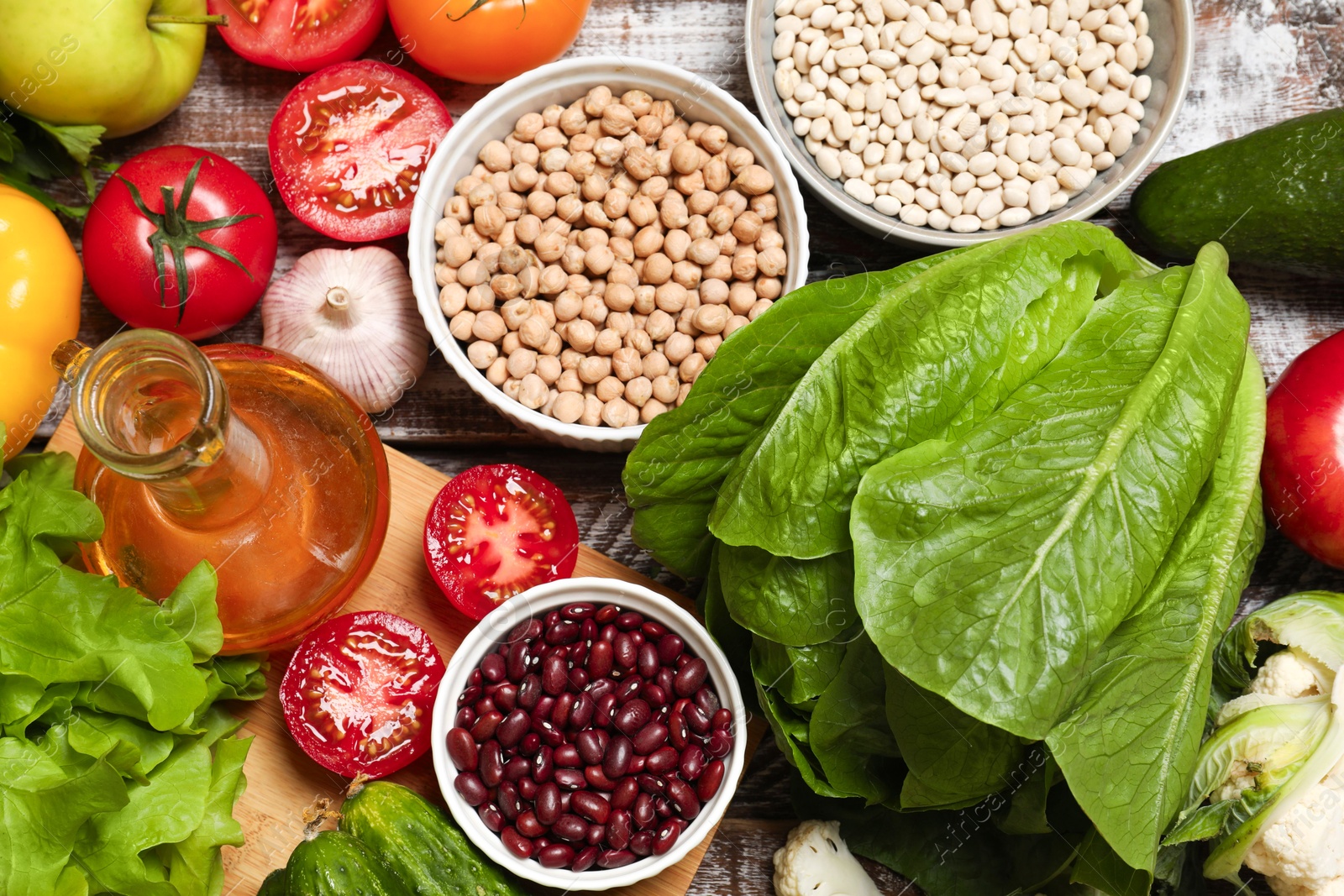 Photo of Different vegetarian products on wooden table, top view