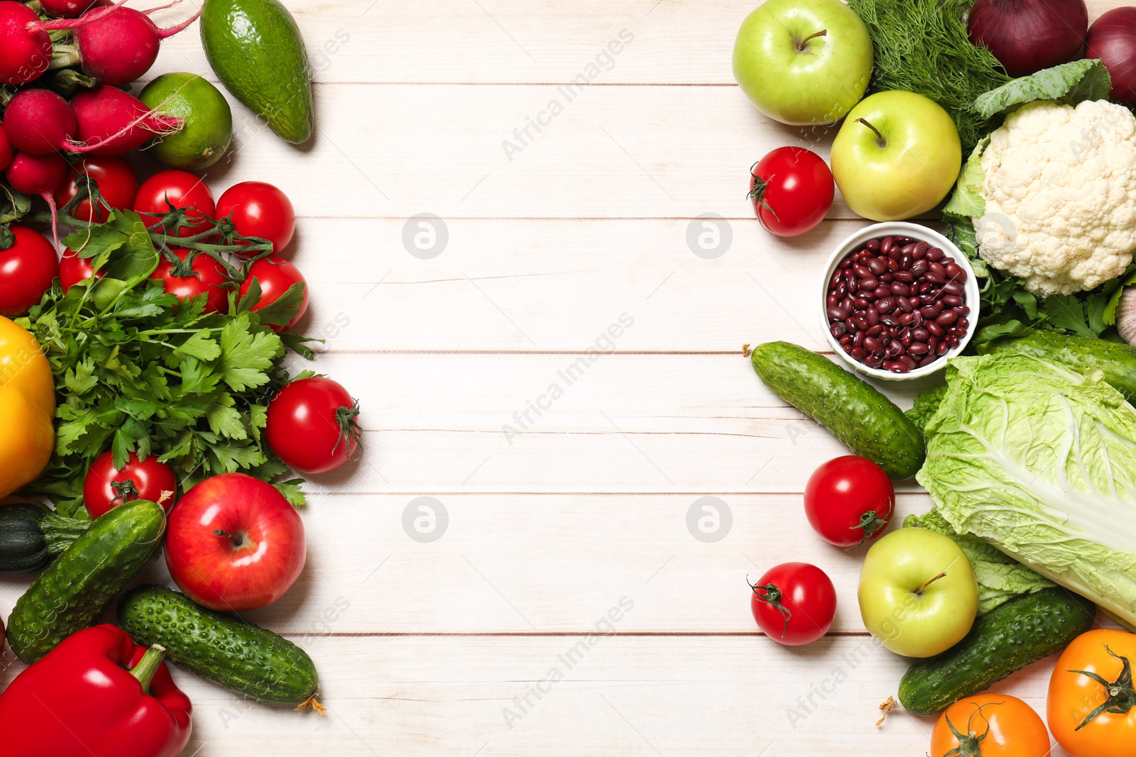 Photo of Different vegetarian products on light wooden table, top view. Space for text