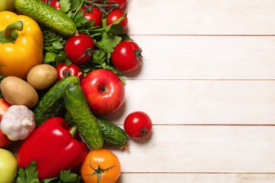 Different vegetarian products on light wooden table, top view. Space for text