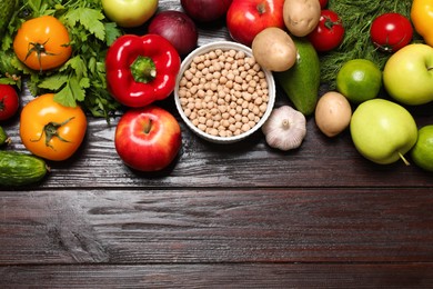 Different vegetarian products on wooden table, top view. Space for text