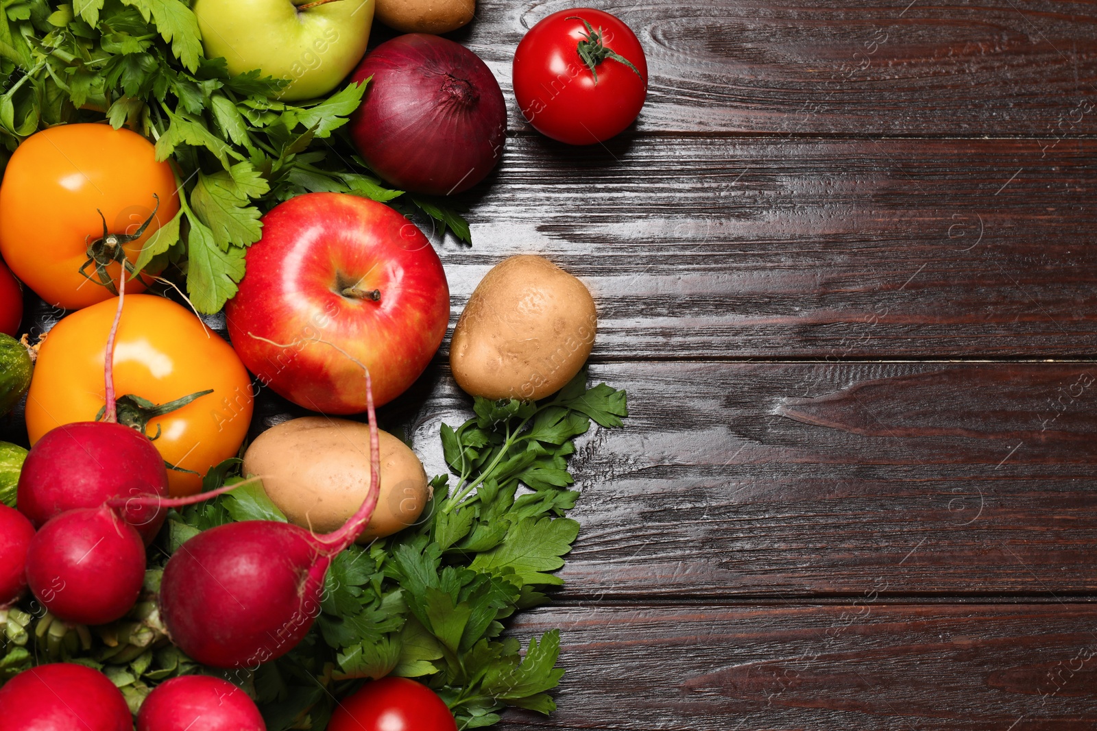 Photo of Different vegetarian products on wooden table, top view. Space for text