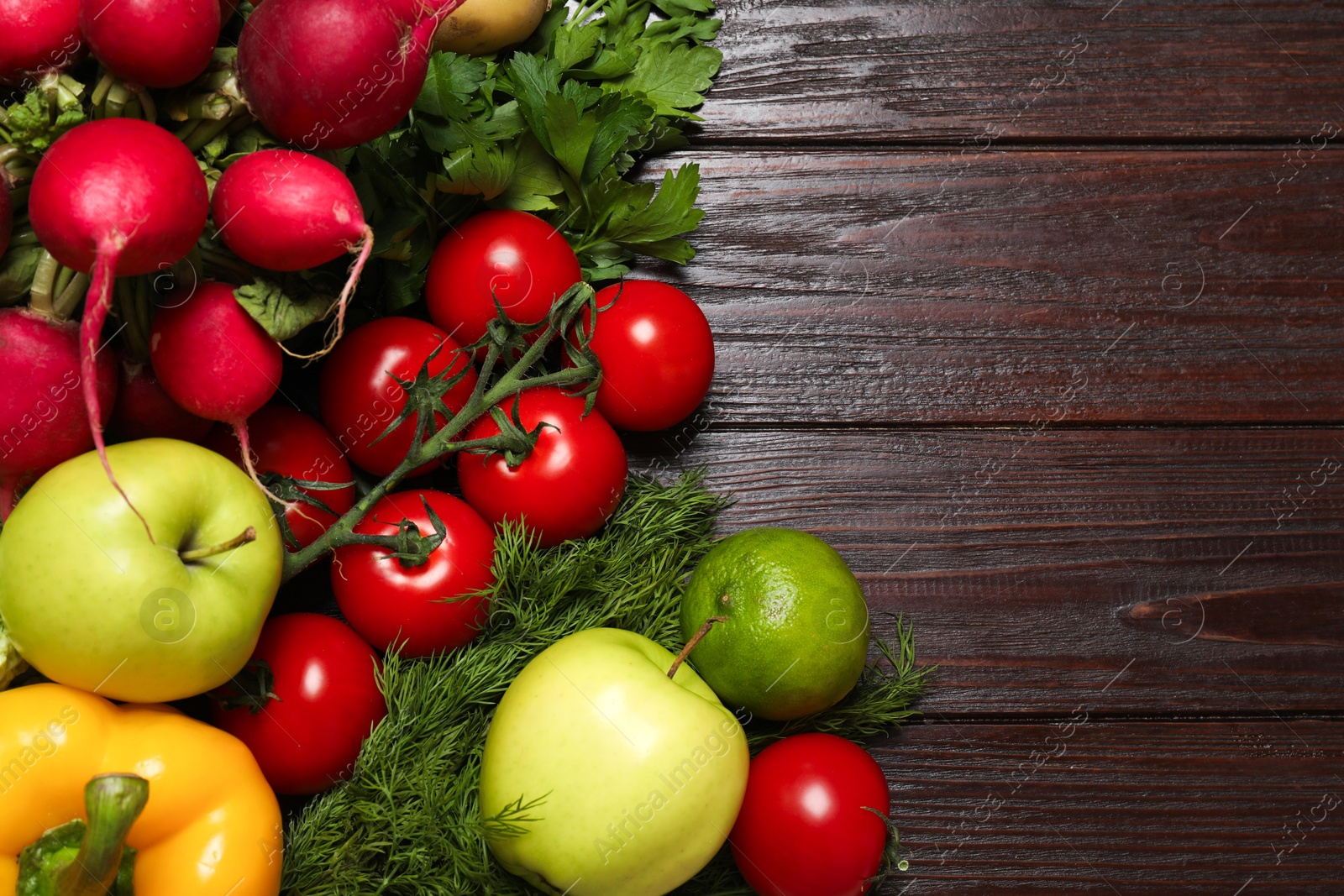 Photo of Different vegetarian products on wooden table, top view. Space for text