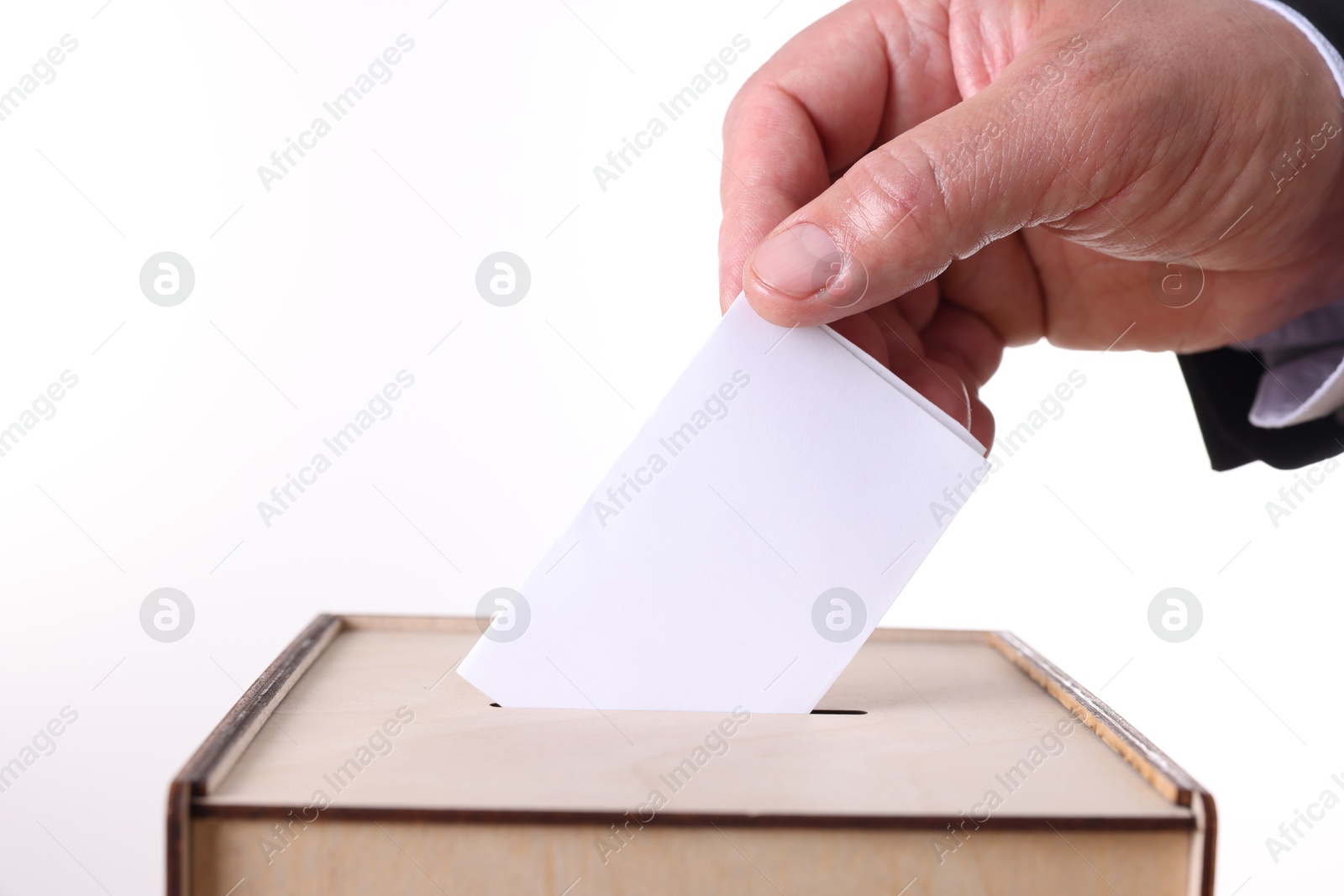 Photo of Man putting his vote into ballot box against white background, closeup