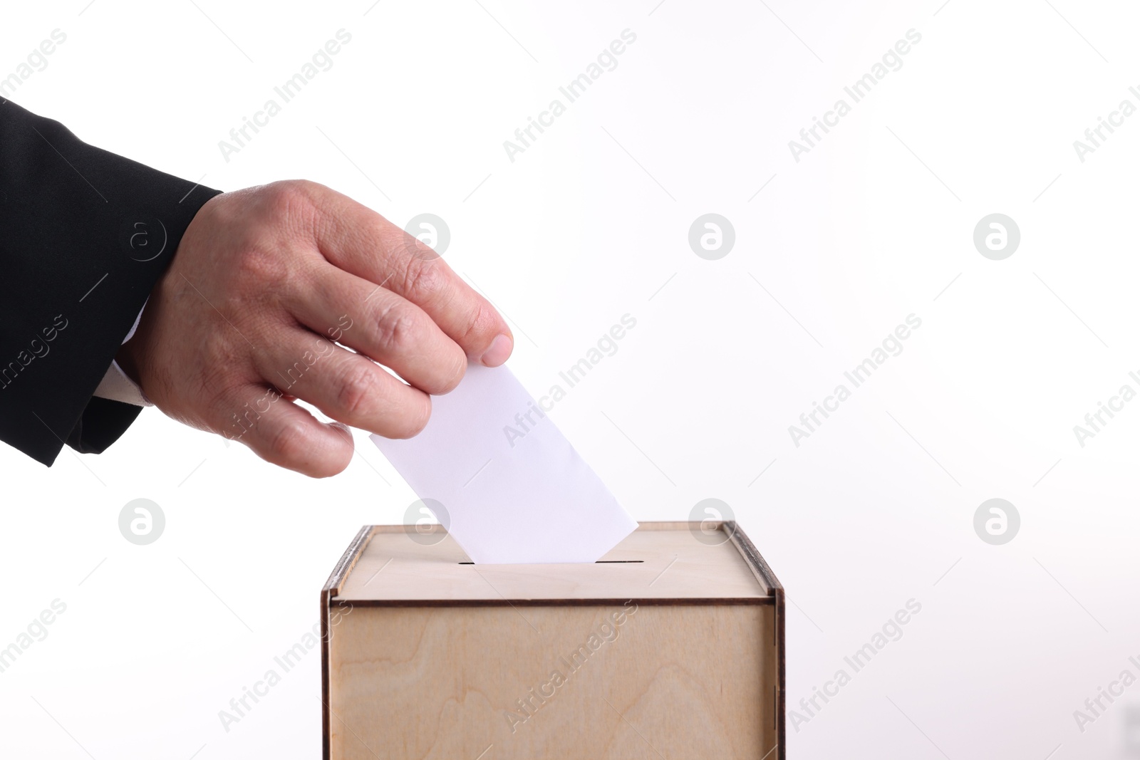 Photo of Man putting his vote into ballot box against white background, closeup