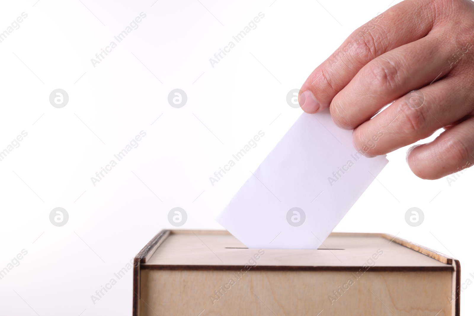 Photo of Man putting his vote into ballot box against white background, closeup