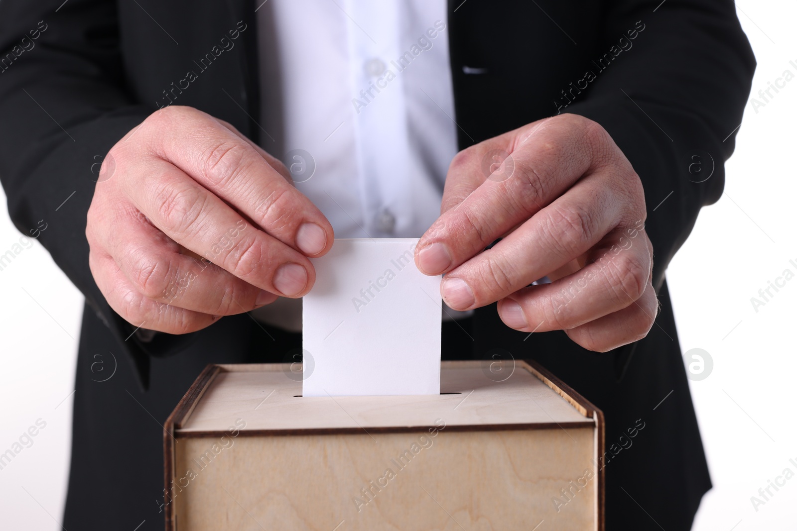 Photo of Man putting his vote into ballot box against white background, closeup