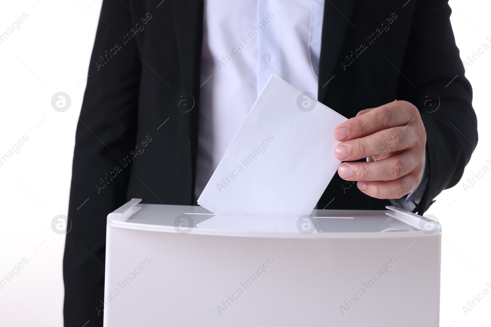 Photo of Man putting his vote into ballot box against white background, closeup