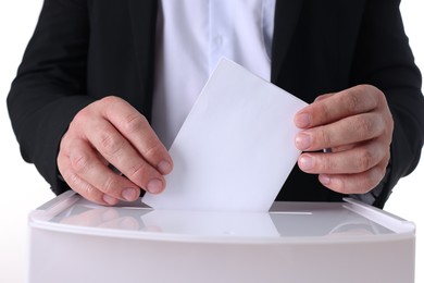 Photo of Man putting his vote into ballot box against white background, closeup