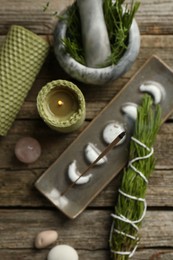 Photo of Flat lay composition with incense stick smoldering in holder on wooden table