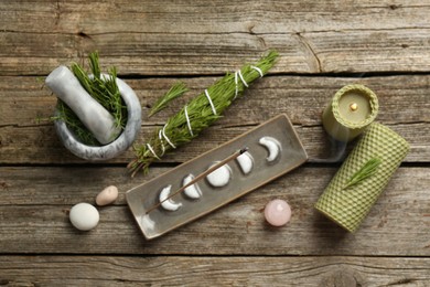 Photo of Flat lay composition with incense stick smoldering in holder on wooden table