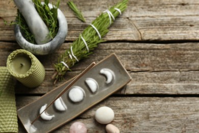 Photo of Flat lay composition with incense stick in holder on wooden table, space for text