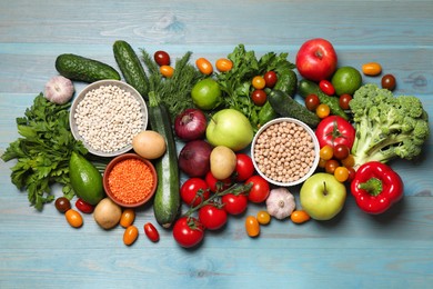 Photo of Source of protein for vegetarians. Different fresh vegetables, fruits and cereals on light blue wooden table, top view