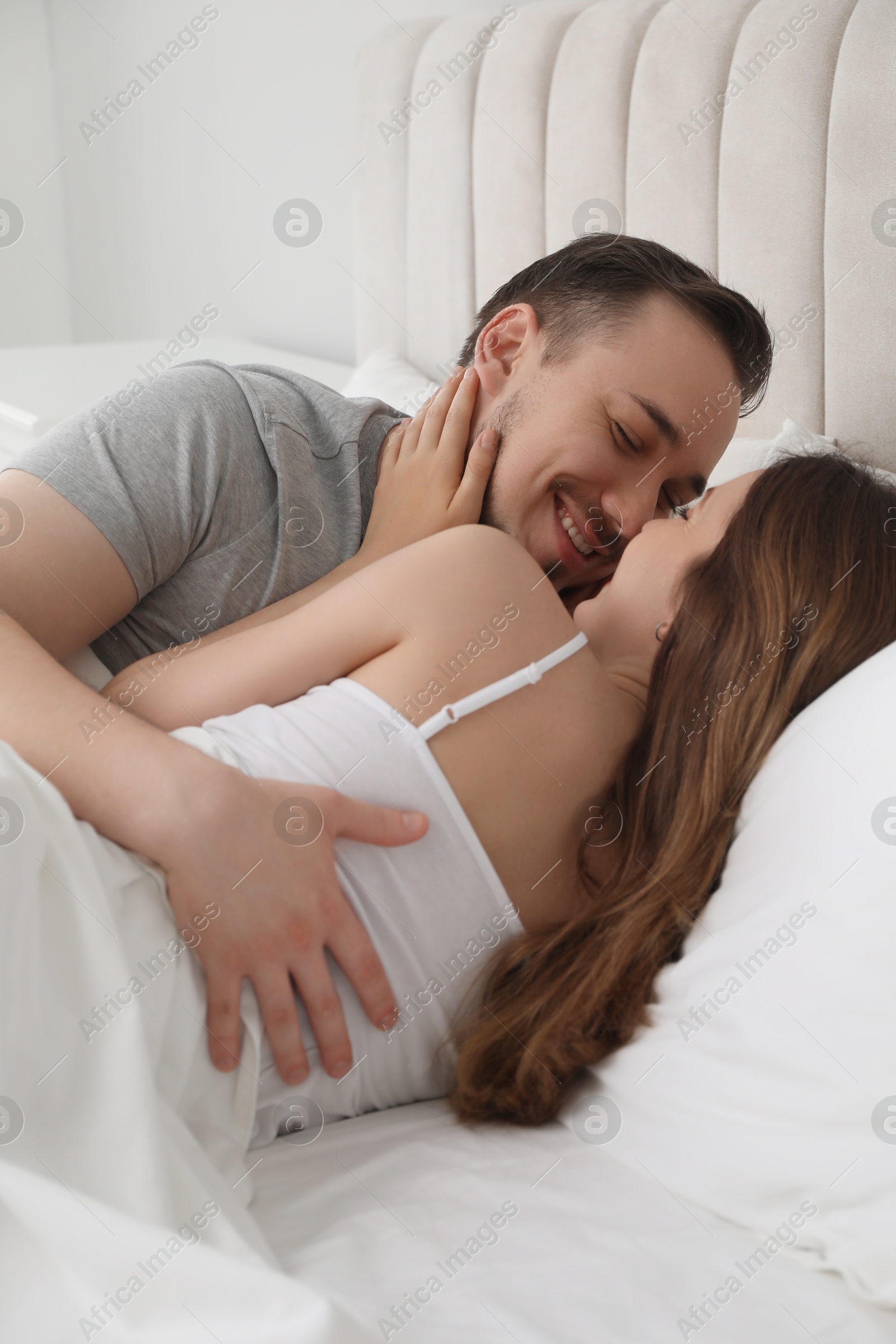 Photo of Lovely couple enjoying time together in bed at morning