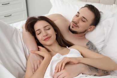 Lovely couple enjoying time together in bed at morning