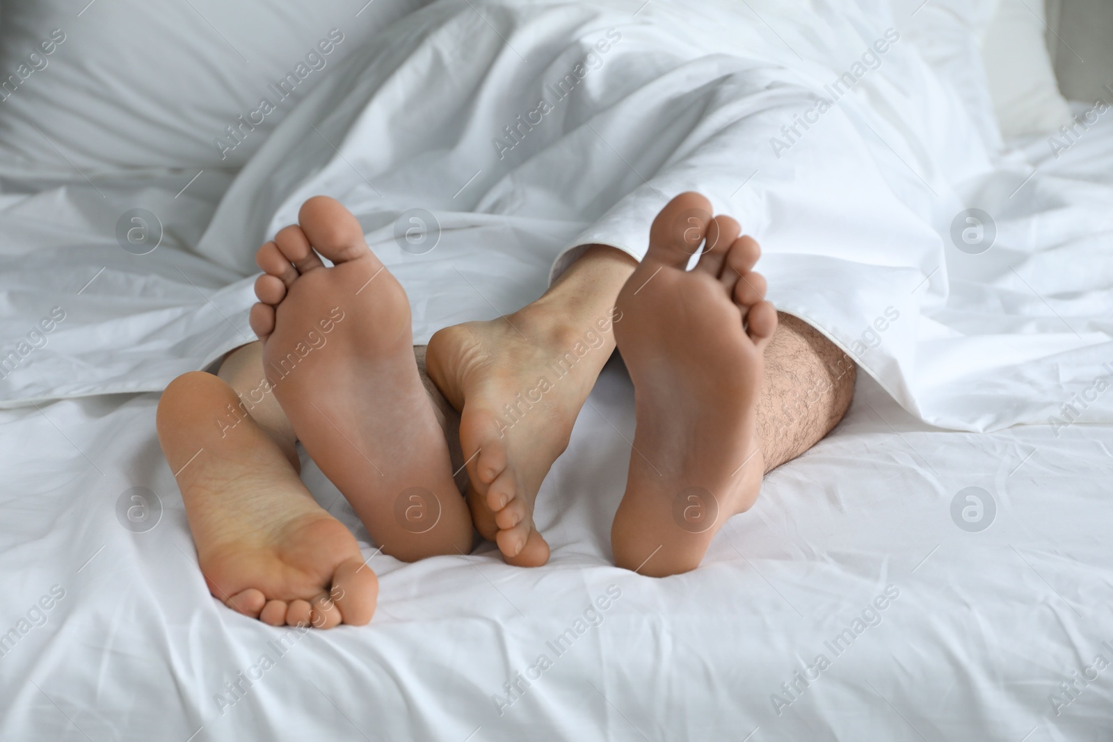 Photo of Lovely couple lying in bed at home, closeup view