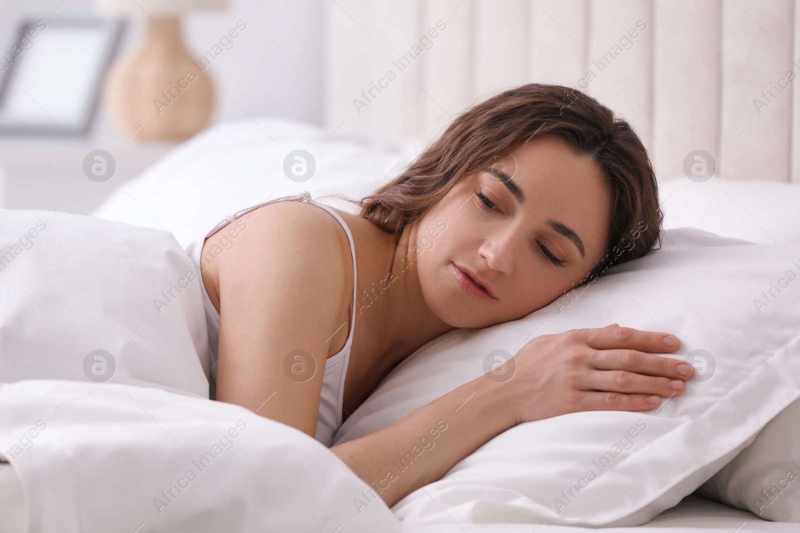 Photo of Bedtime. Beautiful woman lying in bed at home