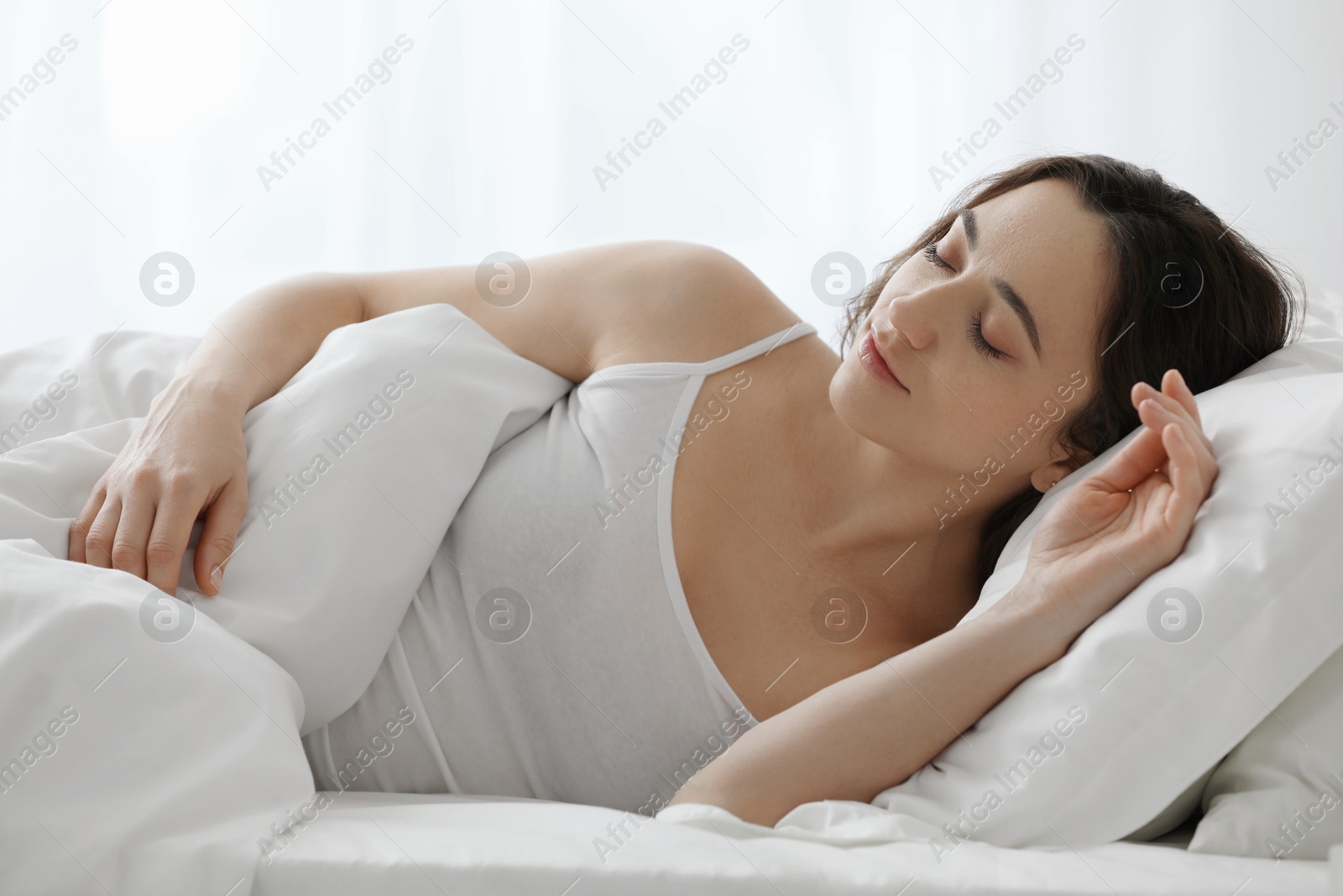 Photo of Bedtime. Beautiful woman sleeping in bed at home