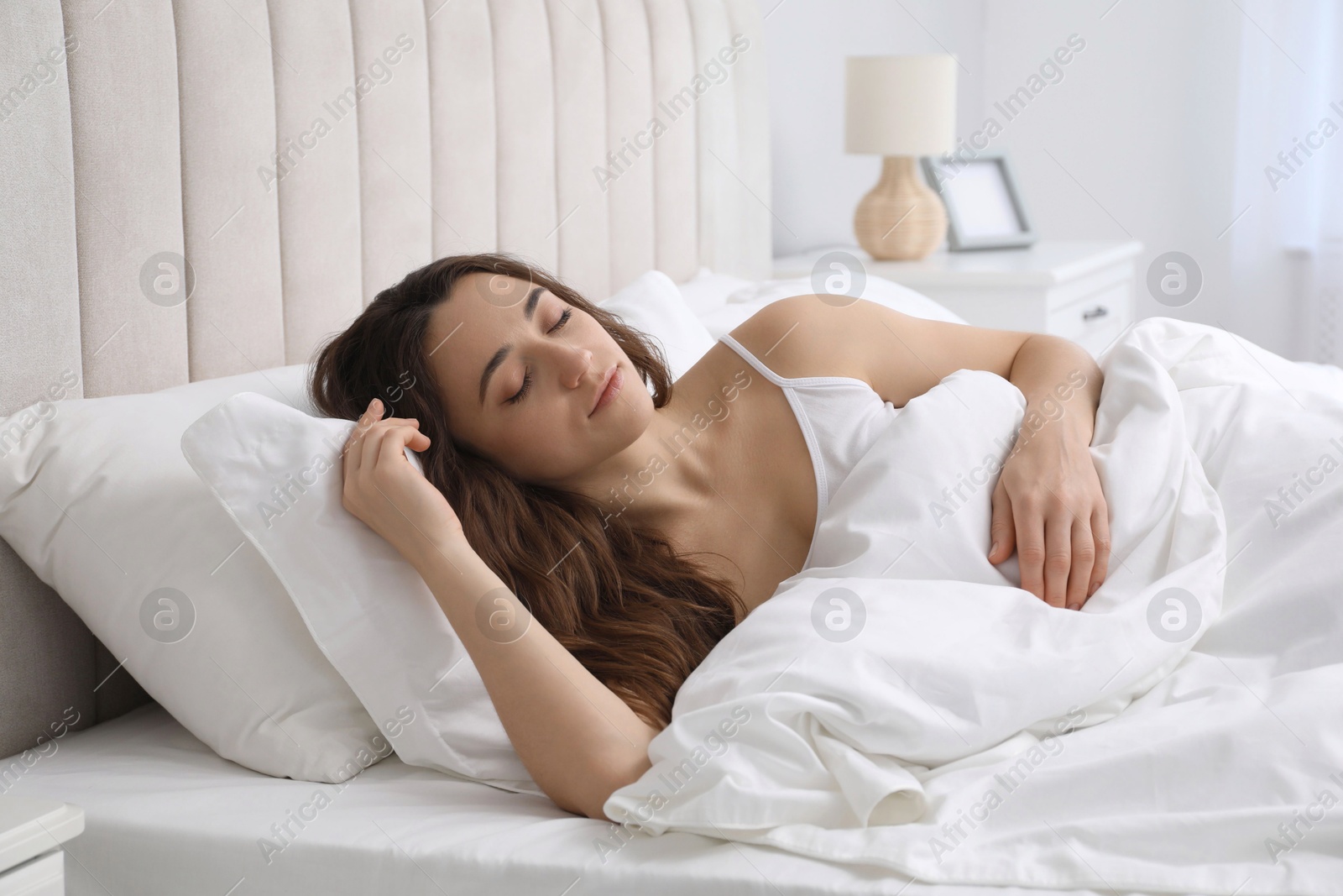 Photo of Bedtime. Beautiful woman sleeping in bed at home