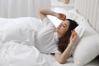 Photo of Bedtime. Beautiful woman lying in bed at home