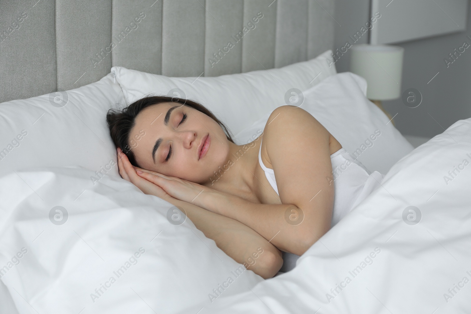 Photo of Bedtime. Beautiful woman sleeping in bed at home