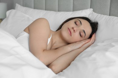 Photo of Bedtime. Beautiful woman sleeping in bed at home