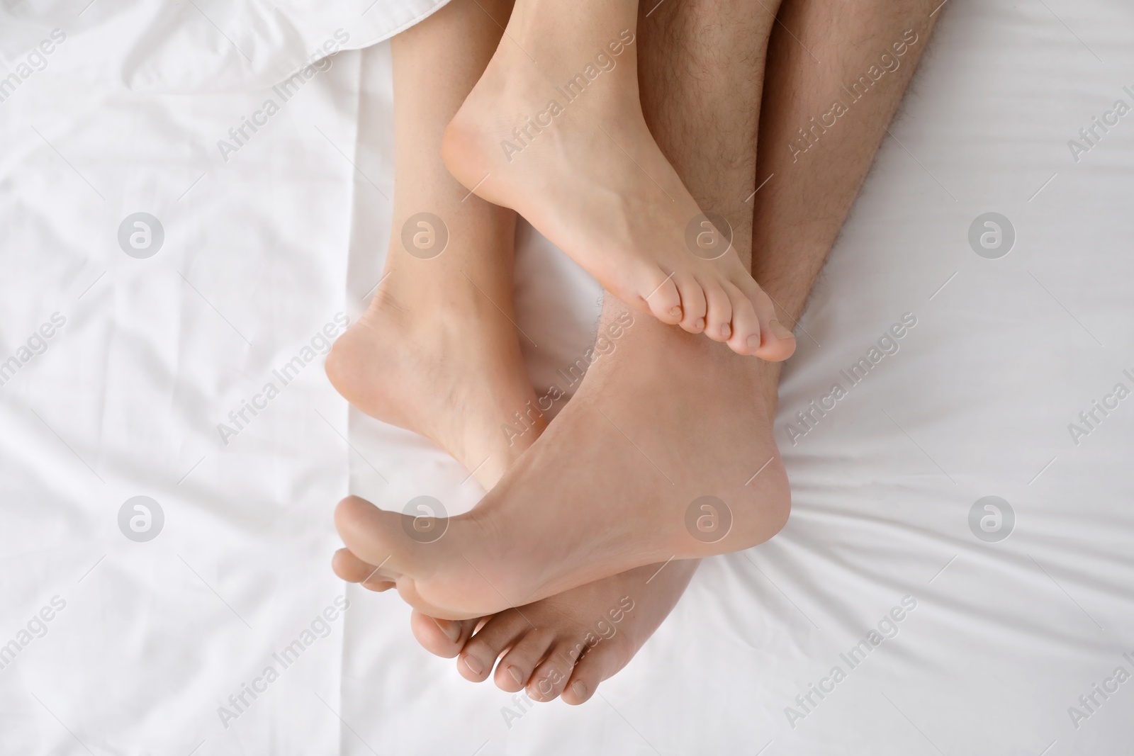 Photo of Lovely couple lying in bed, top view