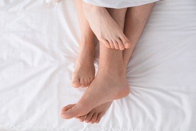 Photo of Lovely couple lying in bed, top view
