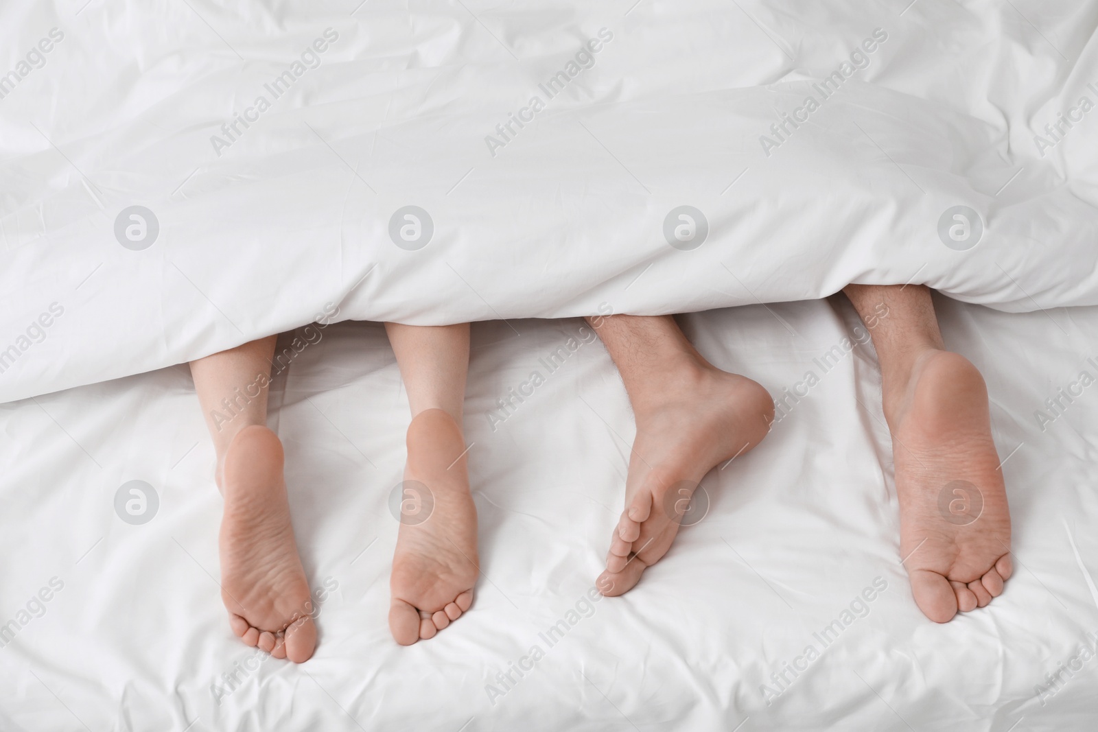 Photo of Lovely couple lying in bed, above view