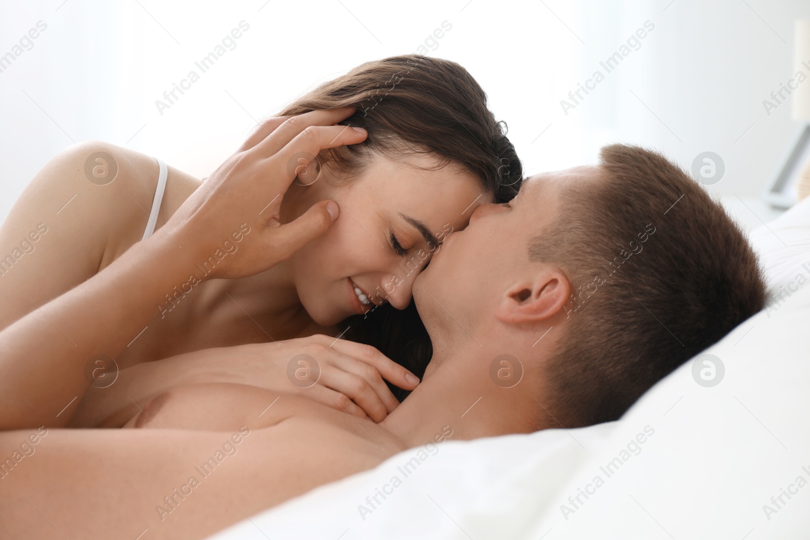 Photo of Lovely couple lying in bed at home