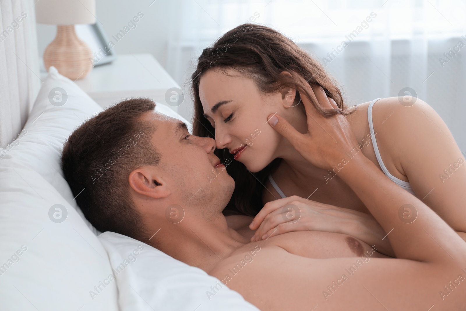 Photo of Lovely couple lying in bed at home