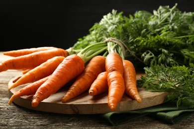 Photo of Tasty ripe juicy carrots on wooden table