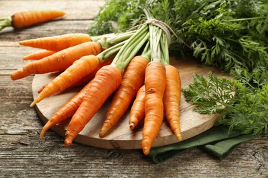 Tasty ripe juicy carrots on wooden table