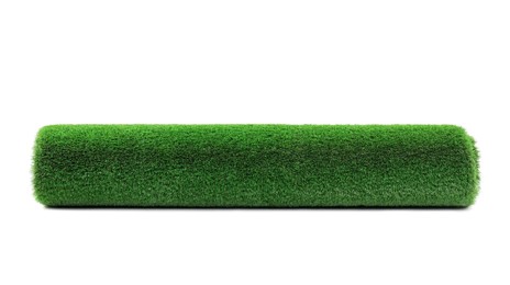 Photo of Roll of green artificial grass isolated on white