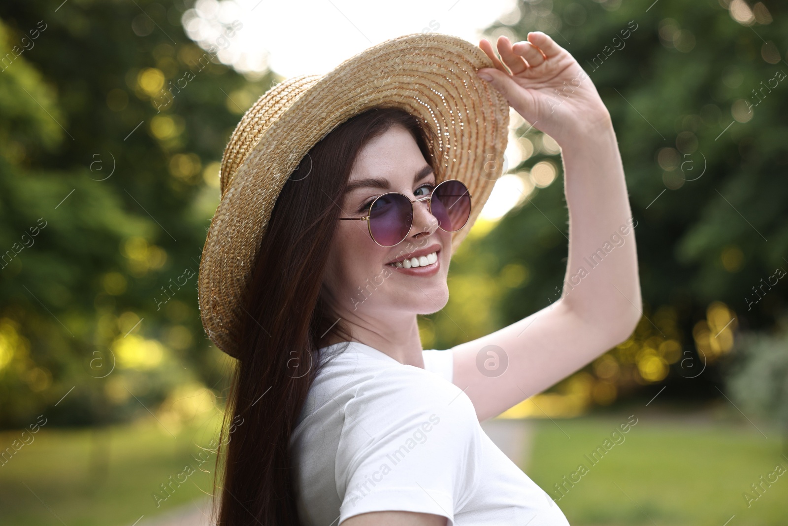 Photo of Portrait of smiling woman in hat outdoors. Spring vibes