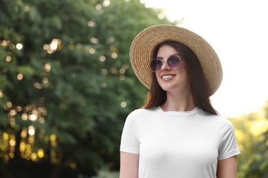 Portrait of smiling woman in hat outdoors, space for text. Spring vibes