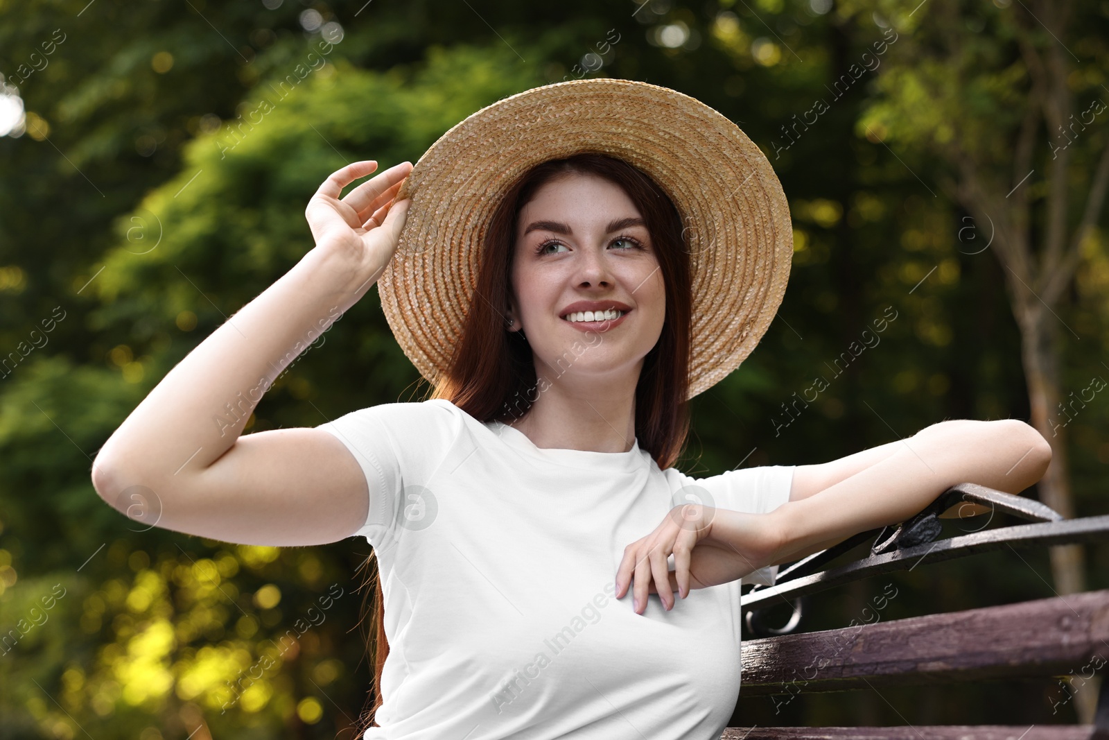 Photo of Portrait of smiling woman in hat outdoors. Spring vibes