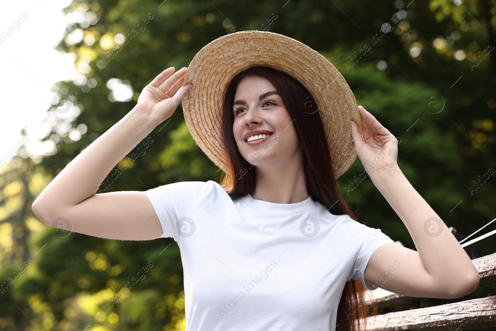 Photo of Portrait of smiling woman in hat outdoors. Spring vibes