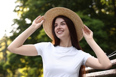 Photo of Portrait of smiling woman in hat outdoors. Spring vibes