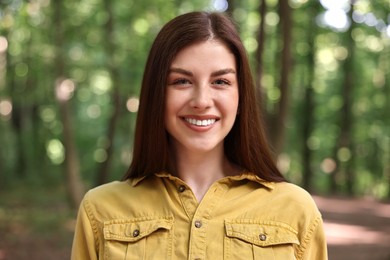 Portrait of smiling woman in forest. Spring vibes