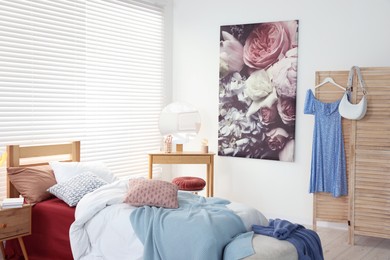 Teen's room interior with modern furniture and beautiful picture on wall