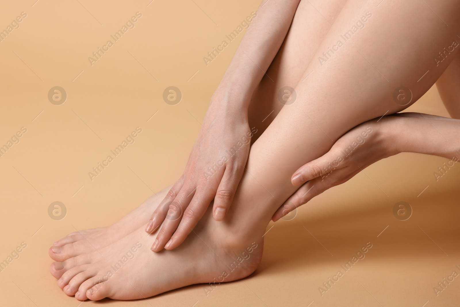 Photo of Closeup view of woman`s groomed feet after care procedure on beige background