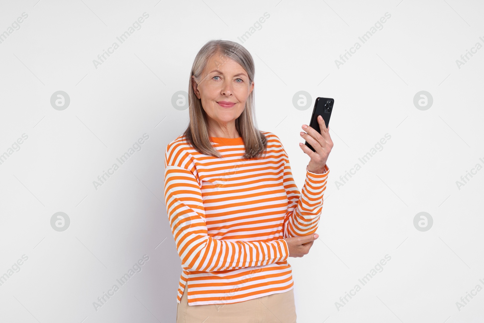 Photo of Senior woman with phone on light grey background