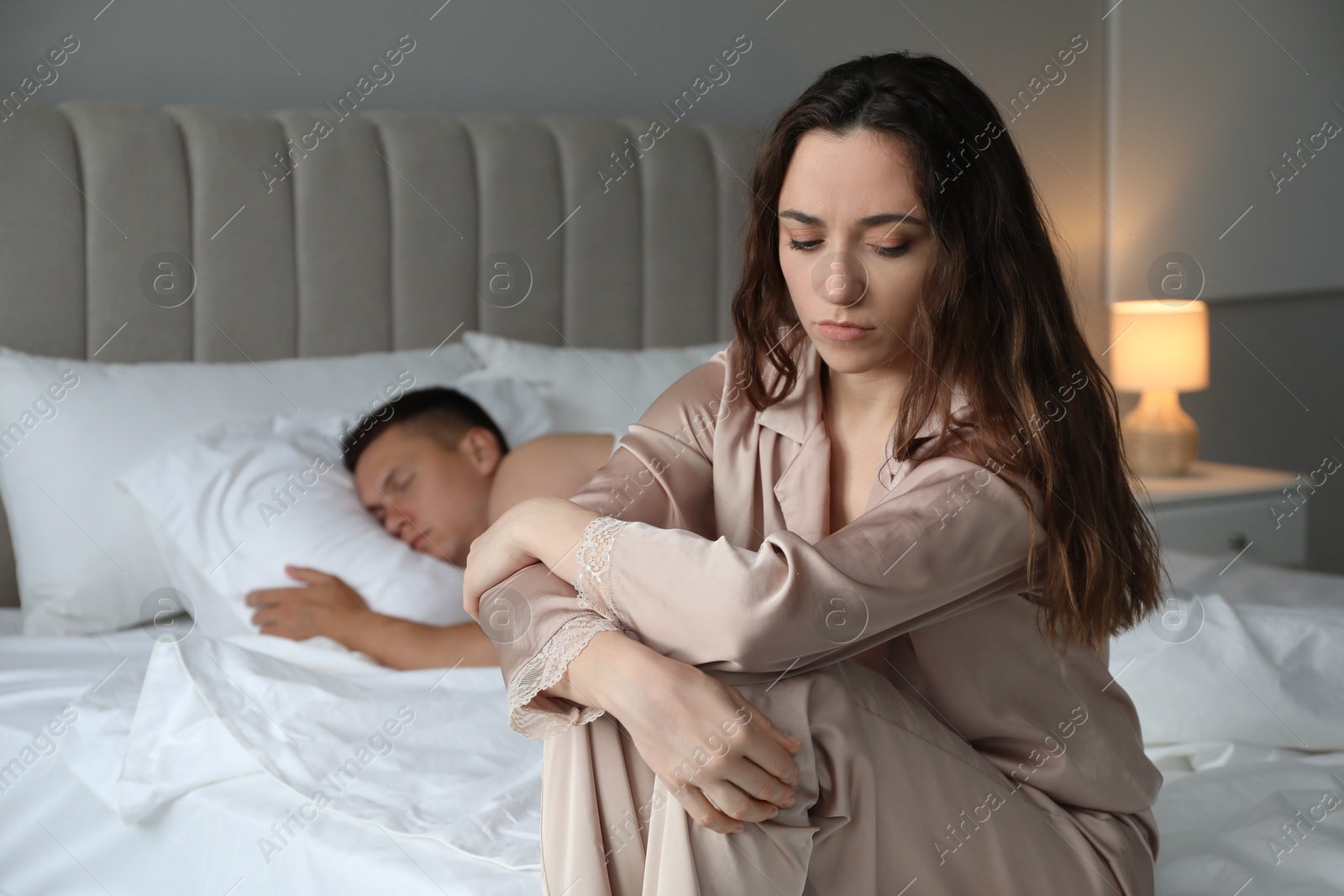 Photo of Offended couple after quarrel in bedroom. Relationship problem