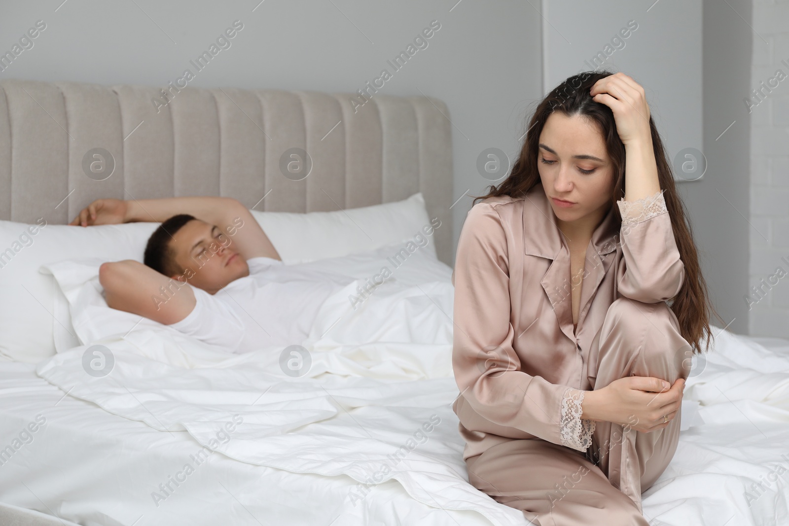 Photo of Offended couple after quarrel in bedroom. Relationship problem