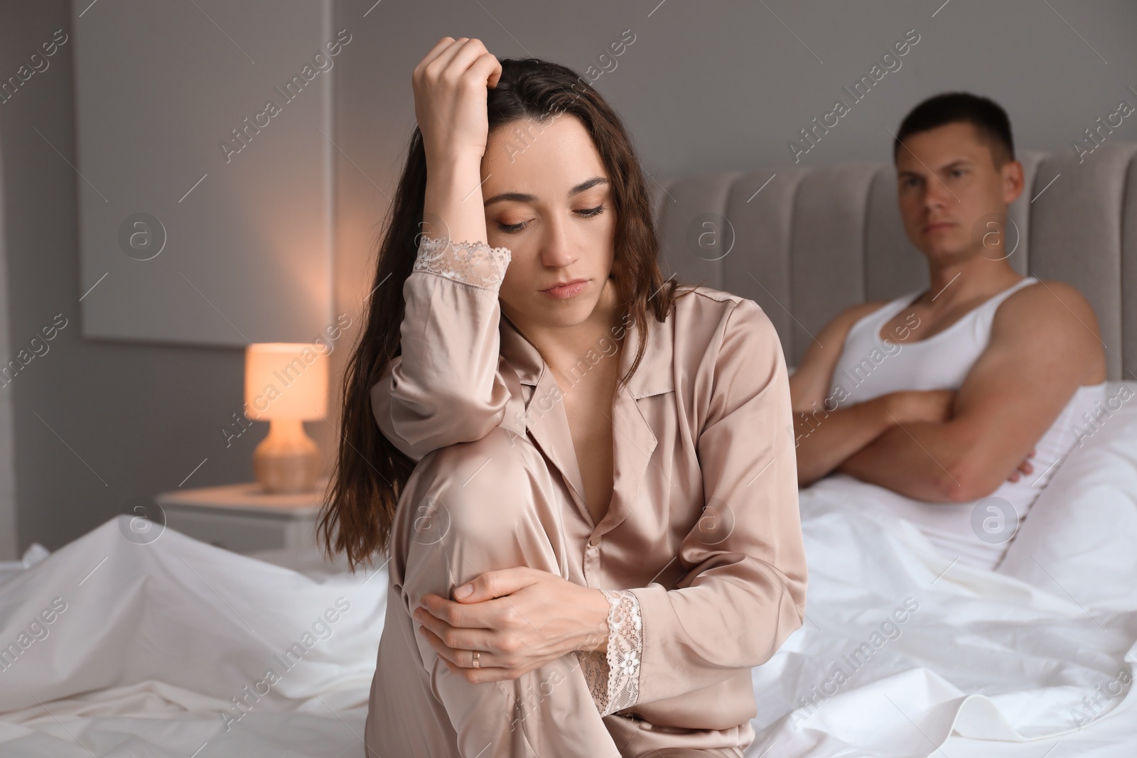 Photo of Offended couple after quarrel in bedroom. Relationship problem