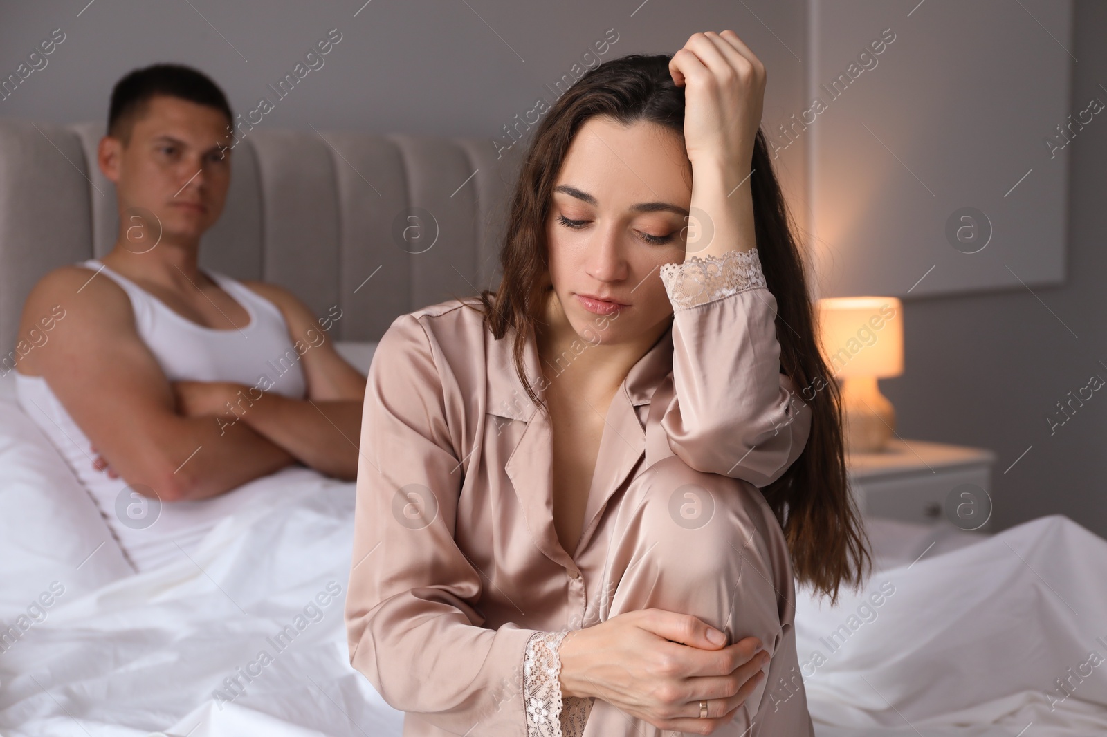 Photo of Offended couple after quarrel in bedroom. Relationship problem